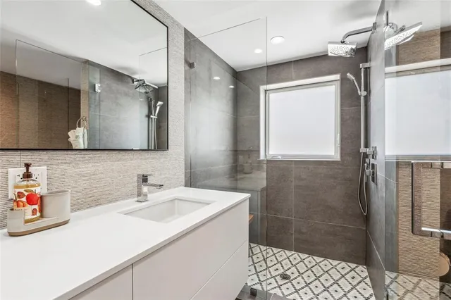 a bathroom with a sink a toilet and shower