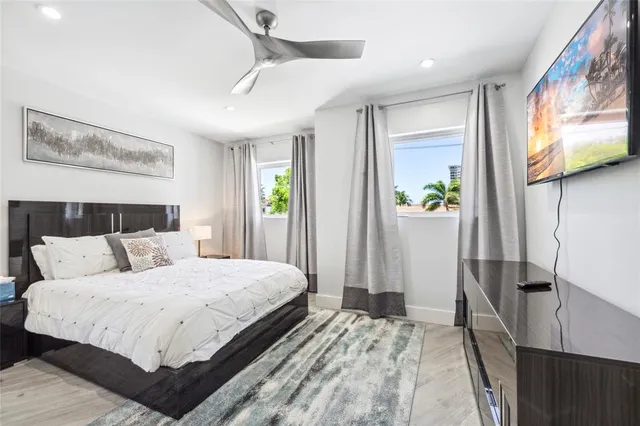 a bedroom with a bed and painting on the wall