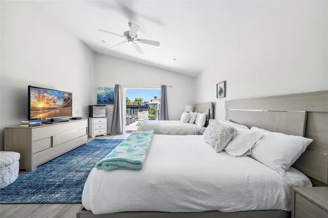 a bedroom with a large bed and a flat screen tv