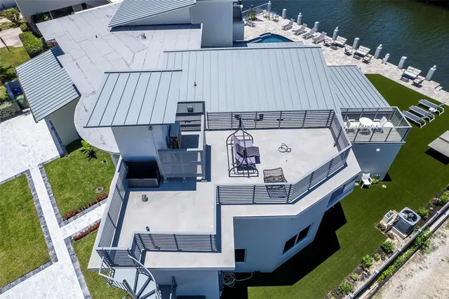 an aerial view of a house with lake view and a floor to ceiling window