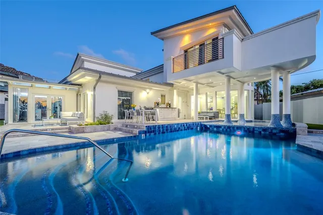 a swimming pool with outdoor seating and yard