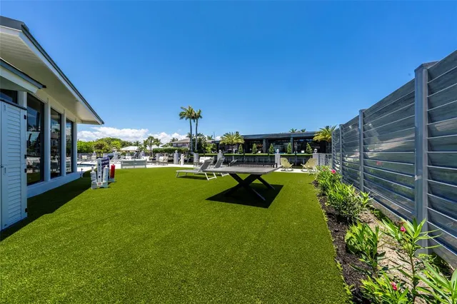 a view of yard with swimming pool outdoor seating and trees