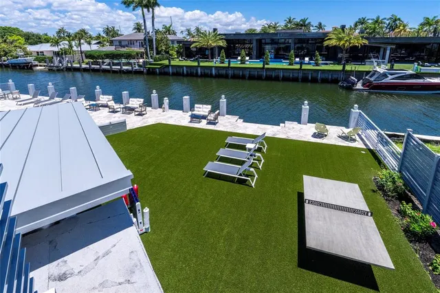 an aerial view of a house with outdoor space lake view and boat