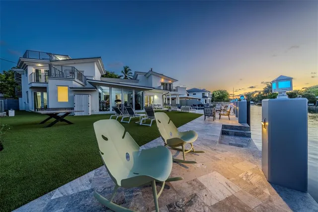 a view of a patio with couches chairs and potted plants