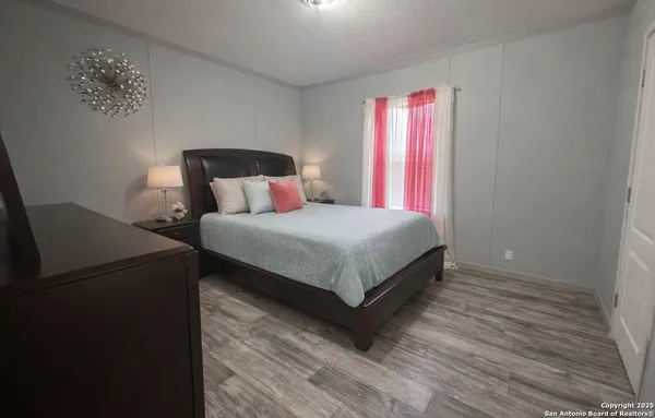 a bedroom with a bed lamp and window