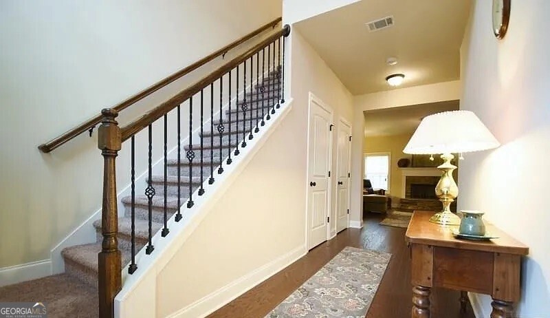 157 Putters Drive Athens, GA 30607 - Photo 15 of 24 a view of staircase with wooden floor and a rug