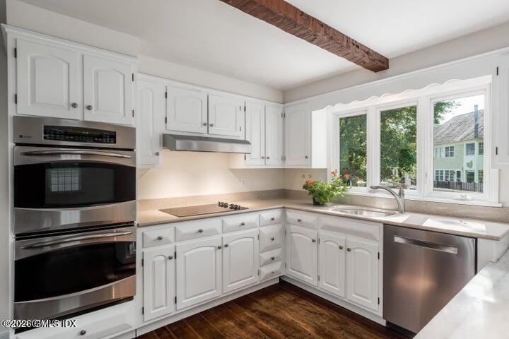 14 Shoal Point Lane Riverside, CT 06878 - Photo 14 of 30 a kitchen with granite countertop white cabinets and stainless steel appliances