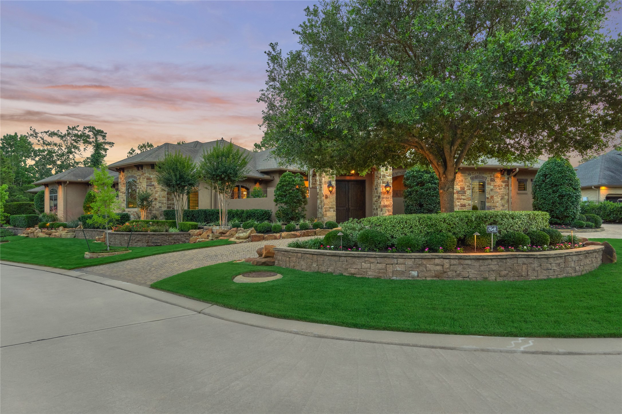 24803 Pearl Crest Lane Spring, TX 77389 - Photo 2 of 50 Impeccable details are on display in this showcase home that harmonizes a superior land/water and hardscape design from the elevated, corner, cul-de-sac lot to special features throughout! Don't miss the private garden area with outdoor shower in the primary bathroom or separate commode rooms, two separate laundry areas, courtyard entrance, mosquito misting system, and many other structural & mechanical treasures! This is a custom home at its finest!