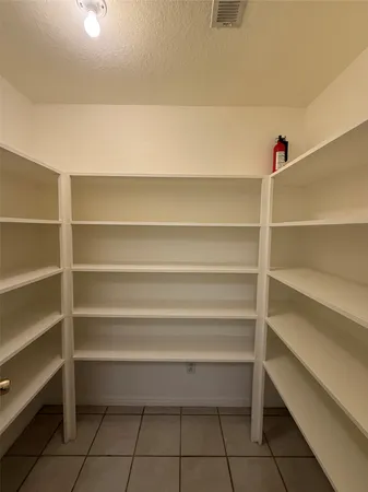 a view of storage and utility room with empty racks