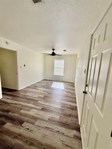 a view of a room with wooden floor and staircase