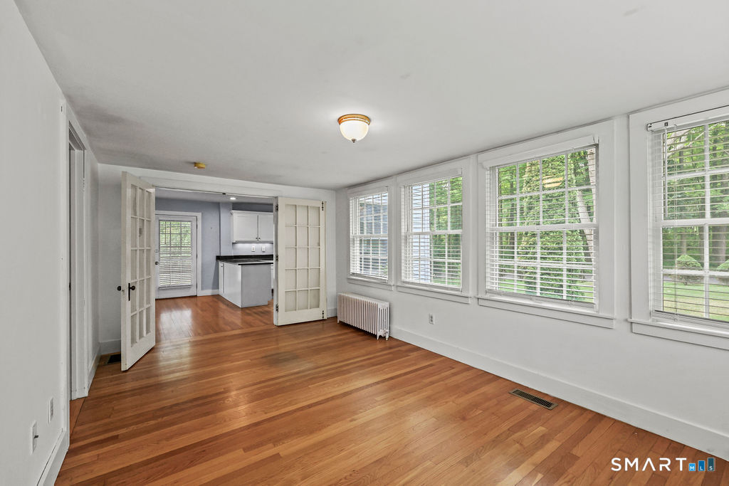 88 Powder Hill Road Middlefield, CT 06455 - Photo 15 of 40 a view of an empty room with a window and wooden floor