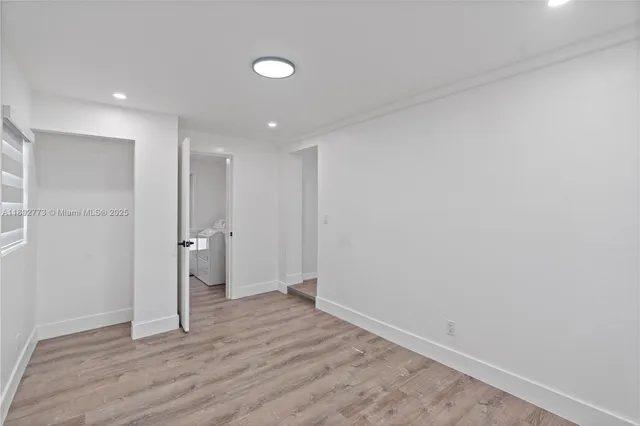 a view of wooden floor and windows in a room