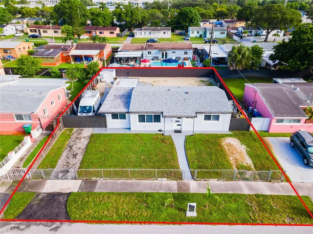an aerial view of multiple houses with outdoor space