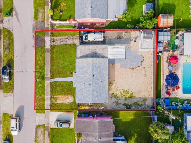 swimming pool view with seating space and plants in the background
