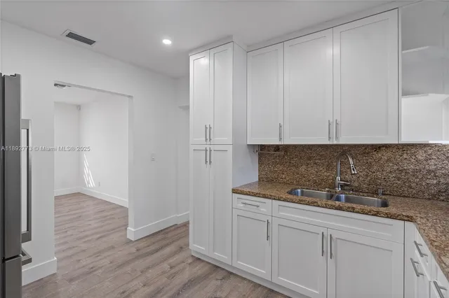 a kitchen with a sink and cabinets