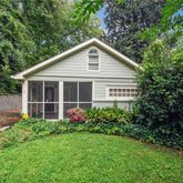 a view of a house with garden and yard