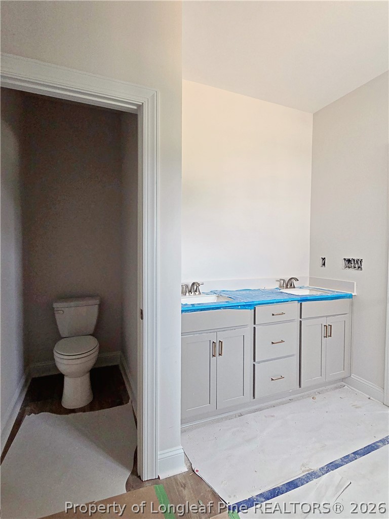 2678 Norrington Road Lillington, NC 27546 - Photo 16 of 31 a spacious bathroom with a toilet sink and mirror