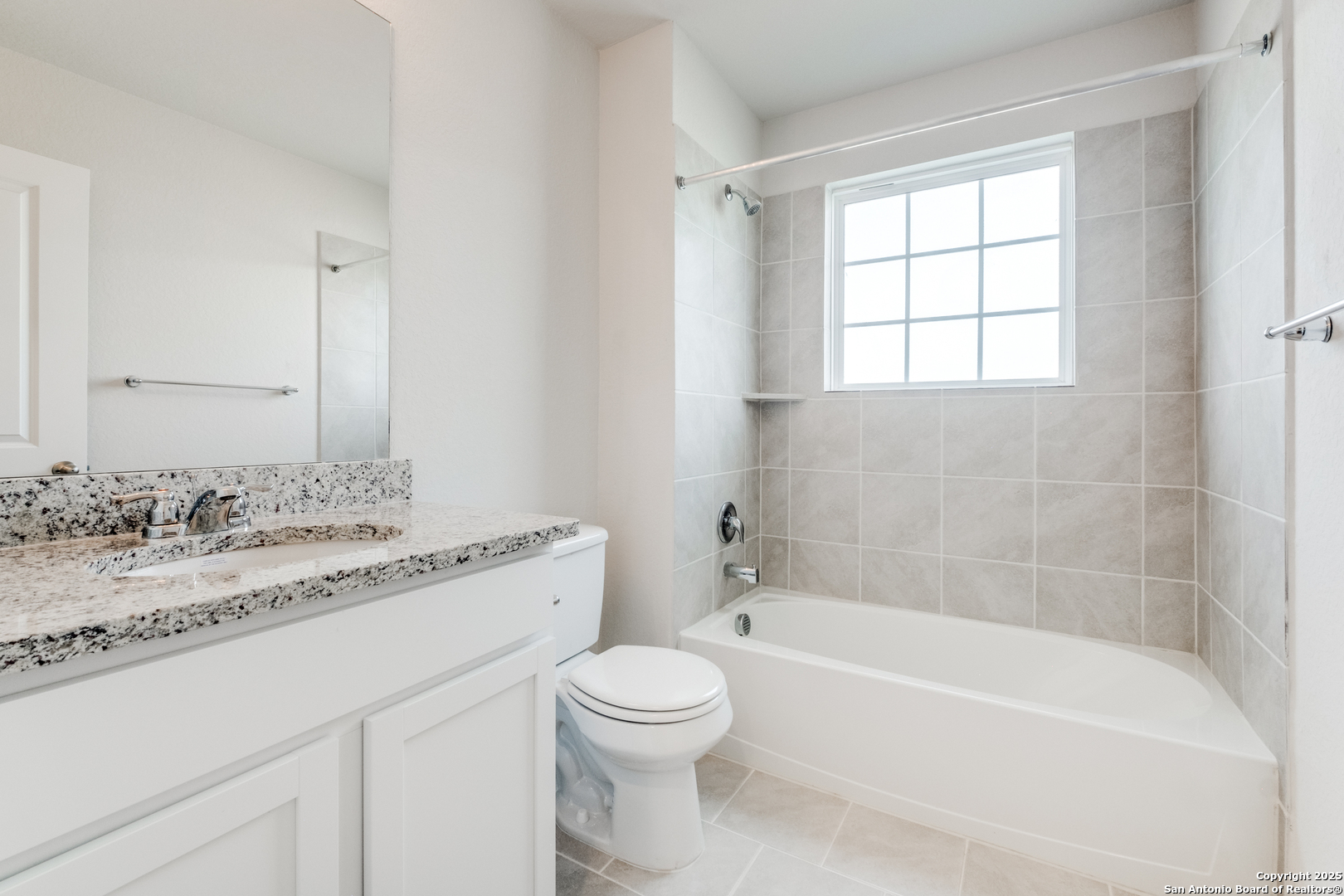 29523 Copper Gate Bulverde, TX 78163 - Photo 16 of 25 a bathroom with a granite countertop sink toilet a large mirror and a bathtub