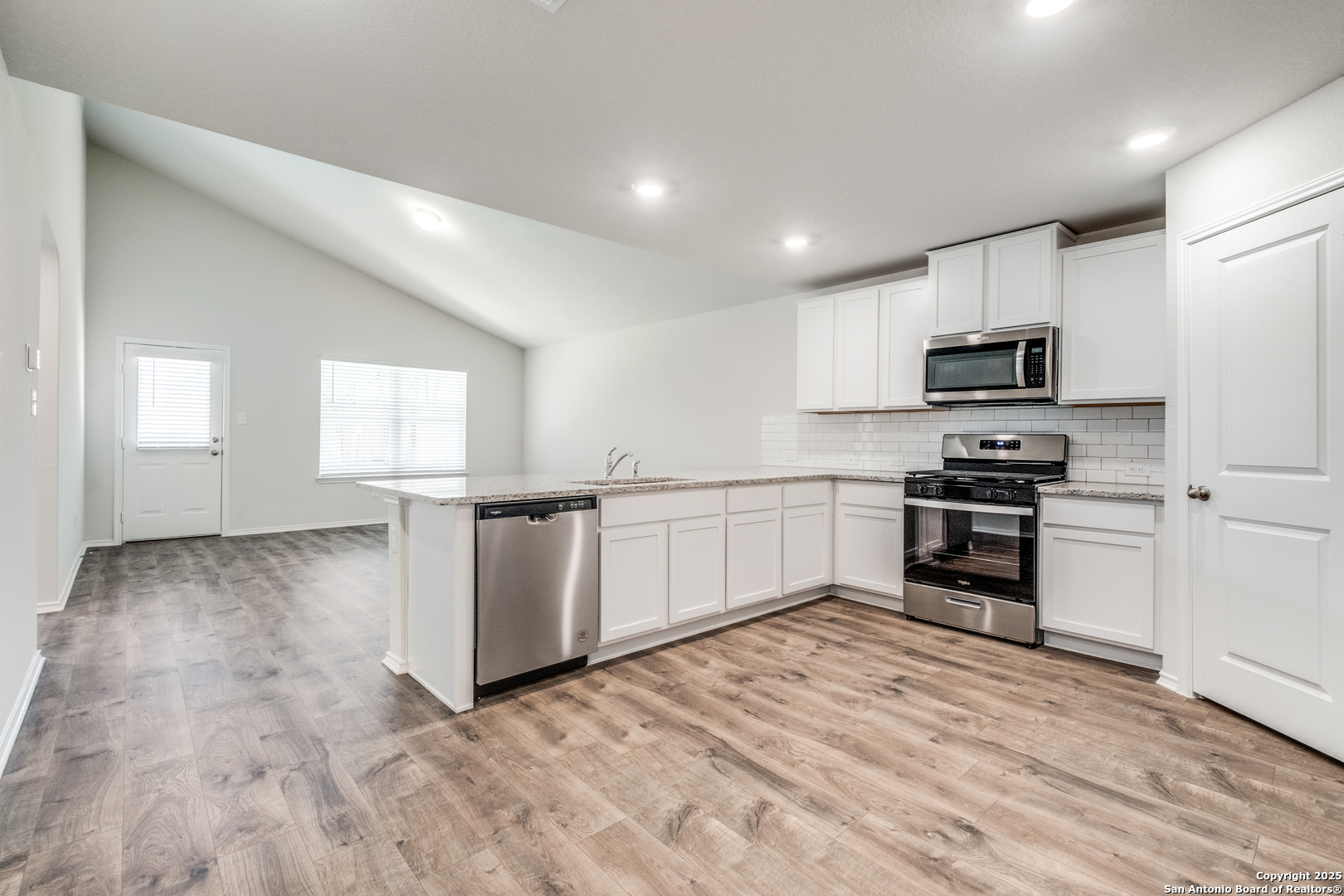 29523 Copper Gate Bulverde, TX 78163 - Photo 8 of 25 a kitchen with granite countertop a refrigerator and a stove top oven