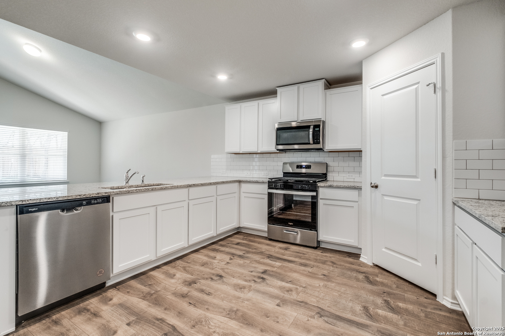 29523 Copper Gate Bulverde, TX 78163 - Photo 10 of 25 a kitchen with granite countertop a refrigerator and a stove top oven