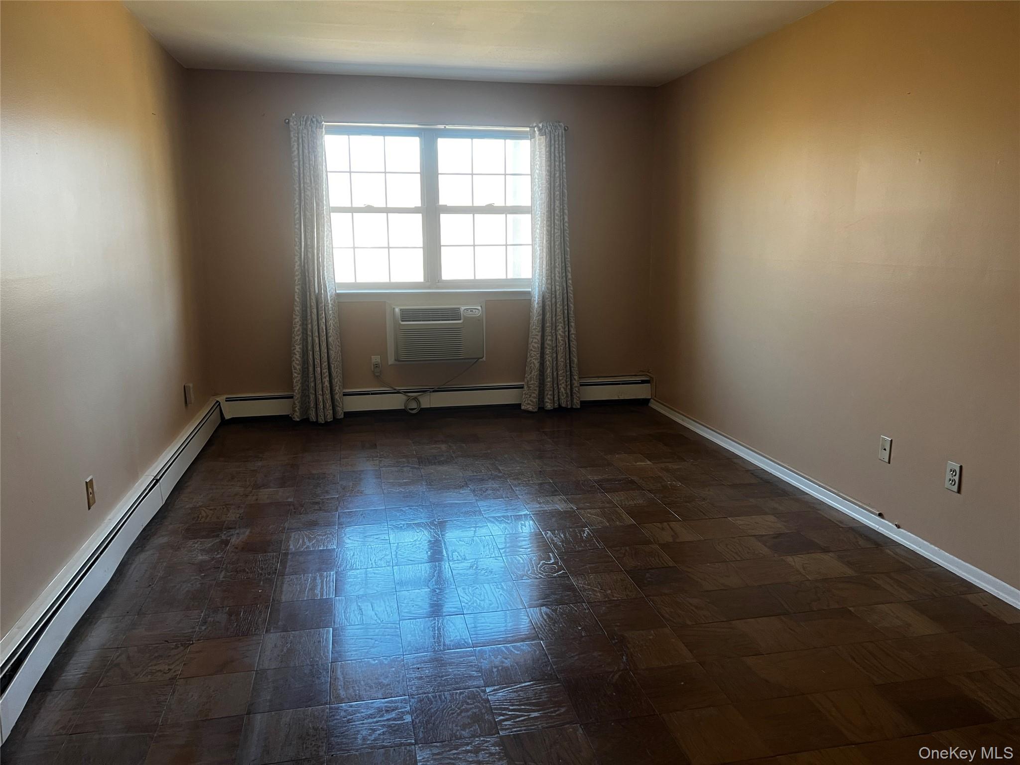1840 Crompond Road, Unit 7C6 Peekskill, NY 10566 - Photo 11 of 16 an empty room with wooden floor and windows