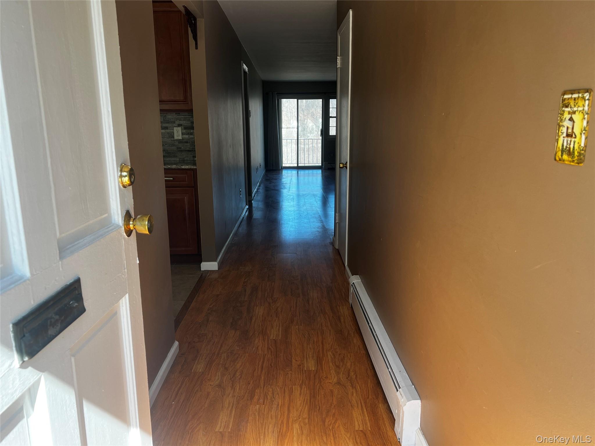 1840 Crompond Road, Unit 7C6 Peekskill, NY 10566 - Photo 3 of 16 a view of a hallway with wooden floor and staircase