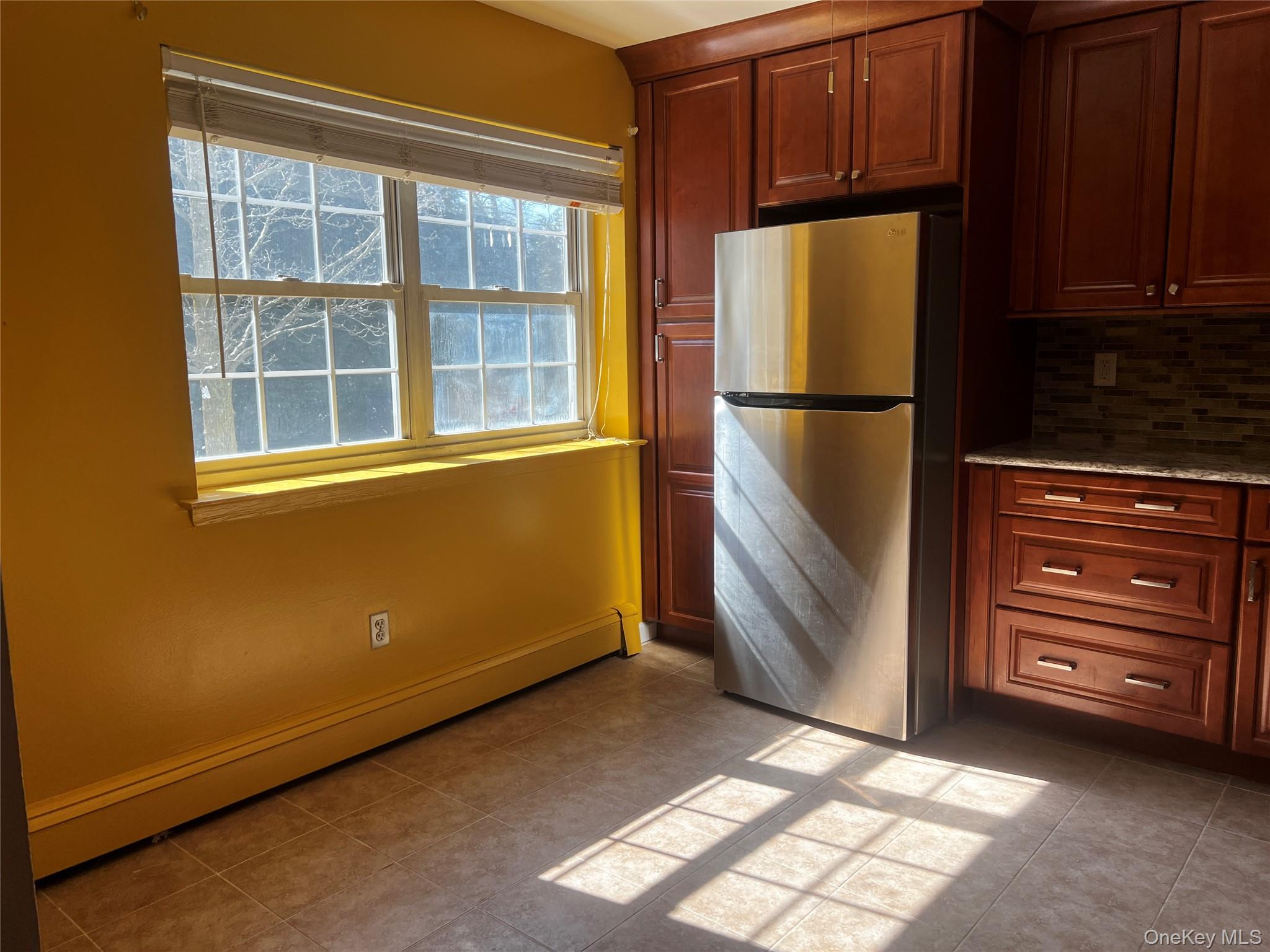 1840 Crompond Road, Unit 7C6 Peekskill, NY 10566 - Photo 5 of 16 a view of kitchen with refrigerator and cabinet
