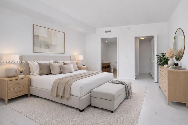a spacious bedroom with a bed and a couch
