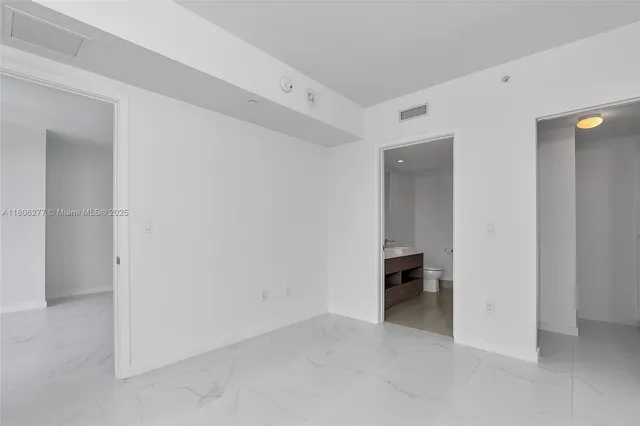 a view of an empty room with a closet