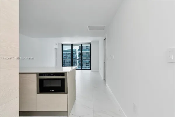 a kitchen with granite countertop a stove and a microwave