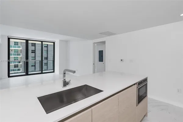 a kitchen with a sink and a refrigerator