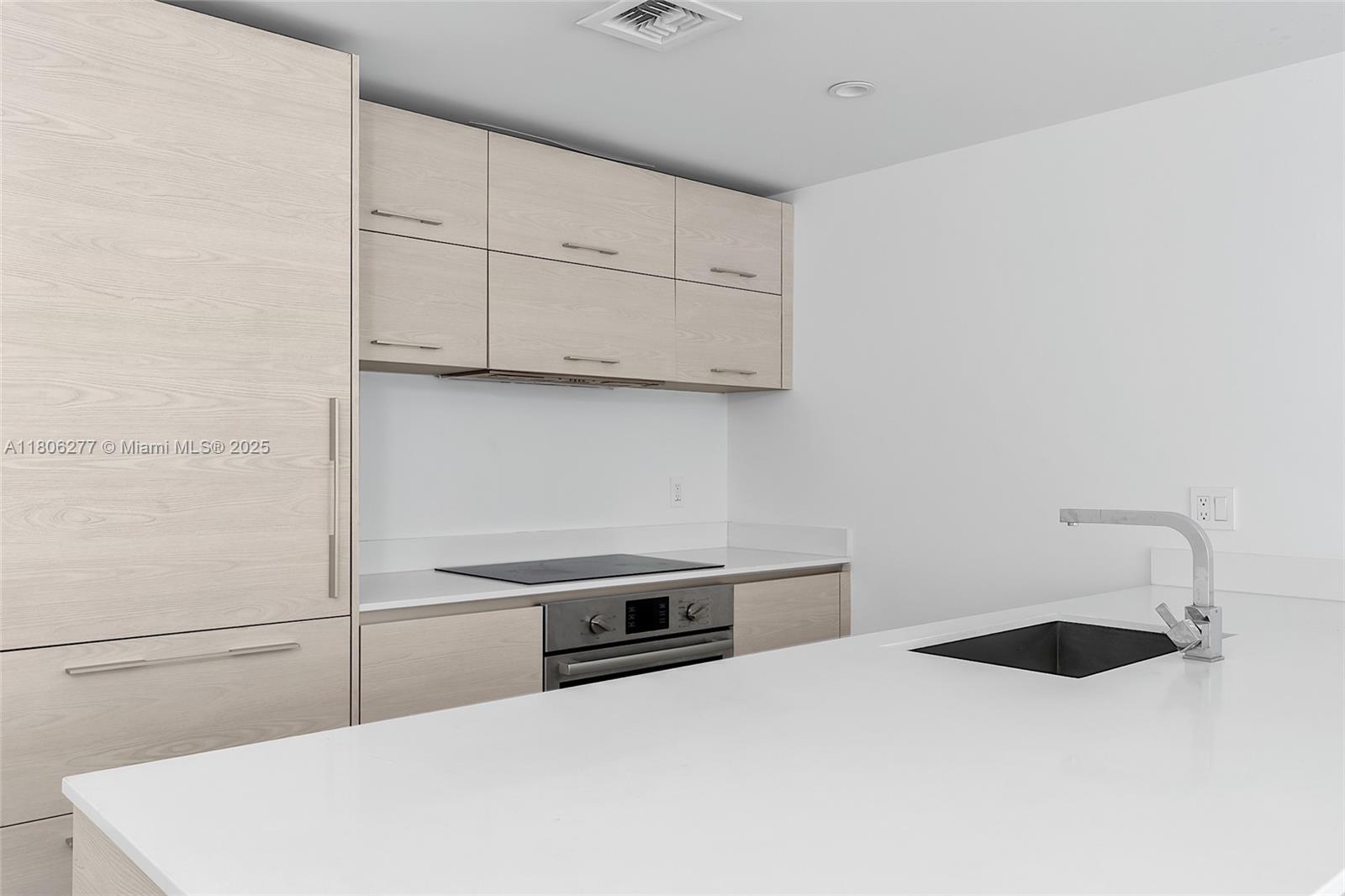 1300 South Miami Avenue, Unit 3211 Miami, FL 33130 - Photo 9 of 38 a kitchen with a white cabinets