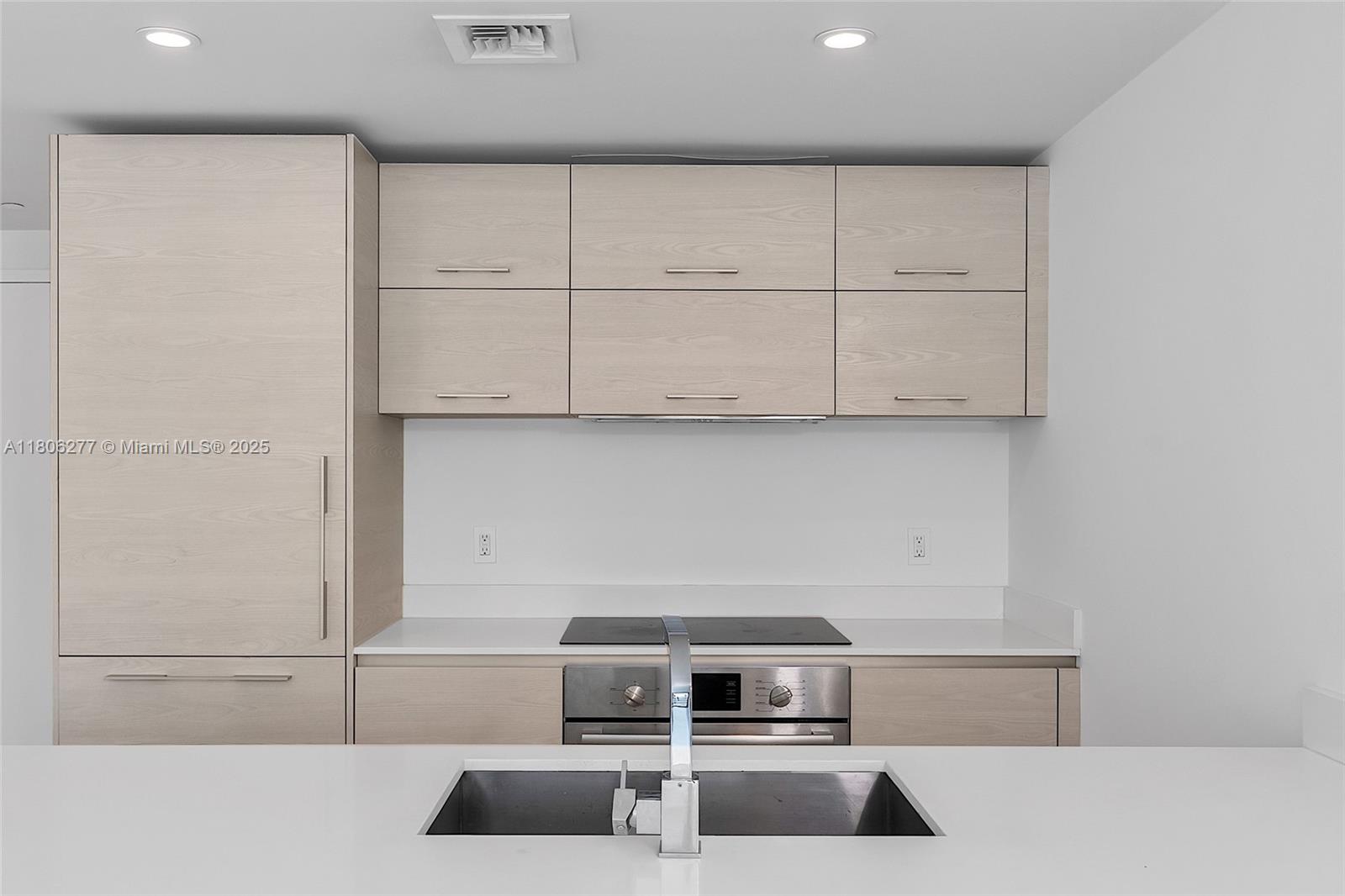 1300 South Miami Avenue, Unit 3211 Miami, FL 33130 - Photo 10 of 38 a kitchen with granite countertop white cabinets and stainless steel appliances