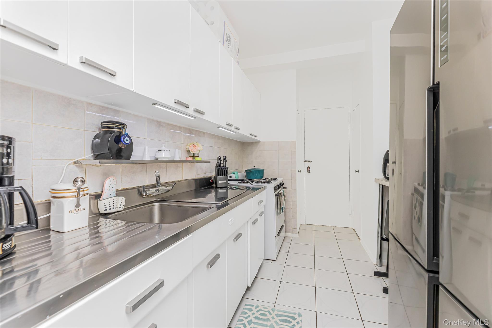 2 Fordham Hill Ovl, Unit 2F Bronx, NY 10468 - Photo 11 of 27 a kitchen with a sink and cabinets