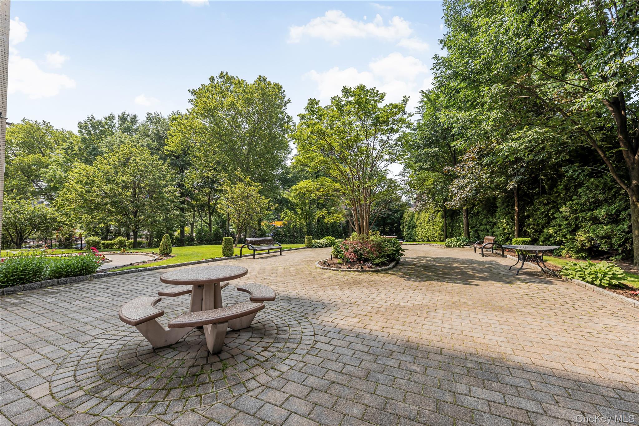 2 Fordham Hill Ovl, Unit 2F Bronx, NY 10468 - Photo 16 of 27 a view of a backyard with a bench and trees