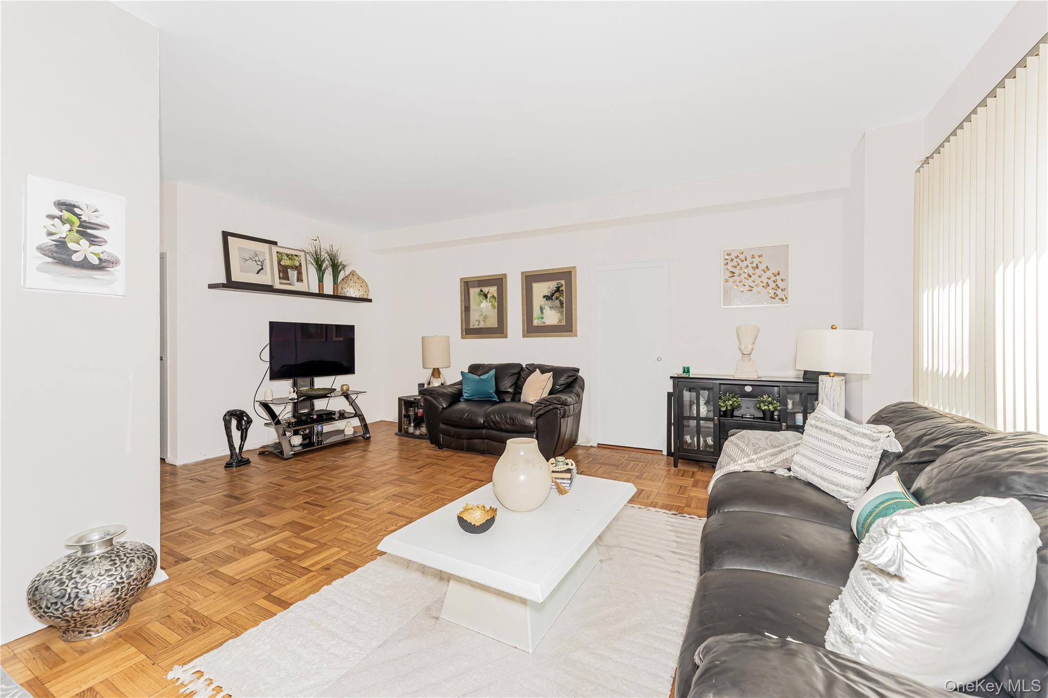 2 Fordham Hill Ovl, Unit 2F Bronx, NY 10468 - Photo 4 of 27 a living room with furniture and a flat screen tv