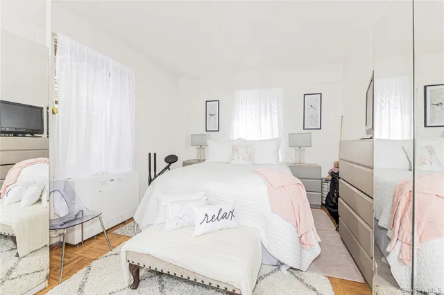 a spacious bedroom with a bed and a window