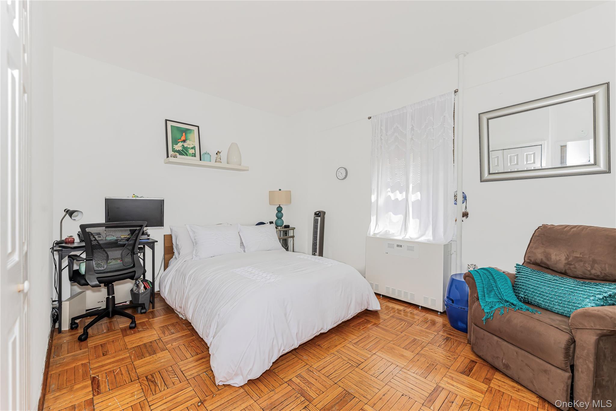 2 Fordham Hill Ovl, Unit 2F Bronx, NY 10468 - Photo 10 of 27 a bedroom with a bed and a couch