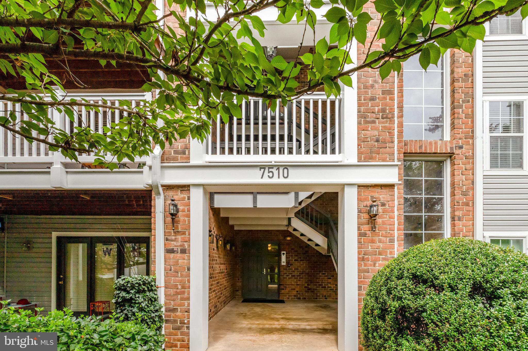 7510 Ashby Lane, Unit J Alexandria, VA 22315 - Photo 1 of 53 a front view of a house with a tree