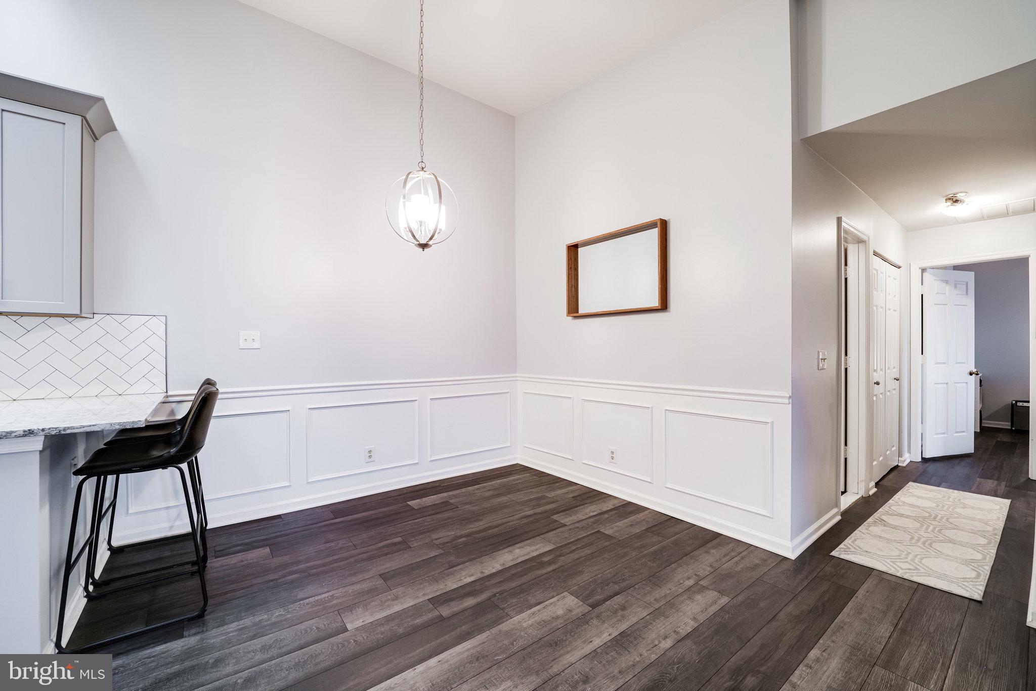 7510 Ashby Lane, Unit J Alexandria, VA 22315 - Photo 11 of 53 a view of a room with wooden floor and a hallway