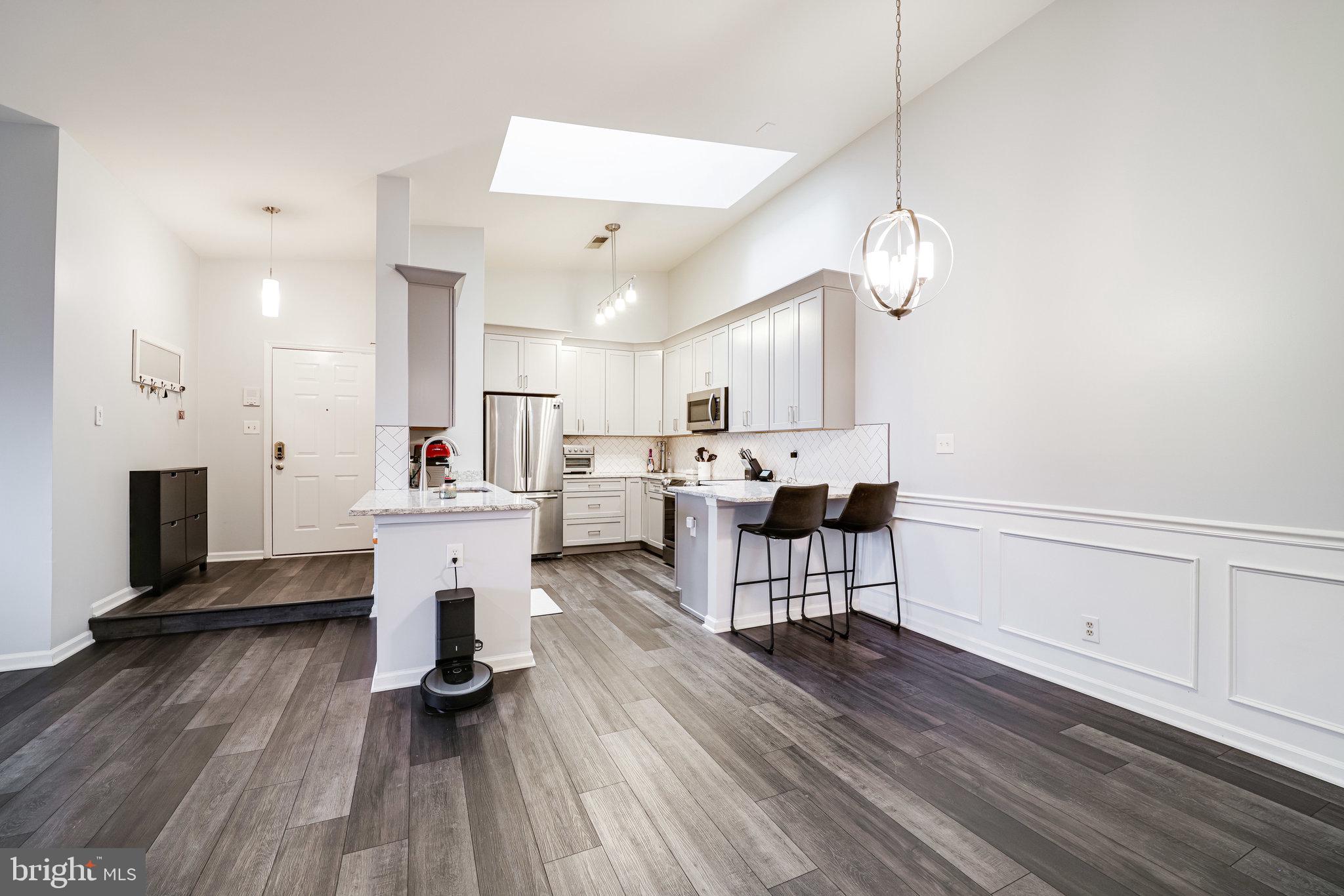 7510 Ashby Lane, Unit J Alexandria, VA 22315 - Photo 12 of 53 a living room with furniture and a wooden floor