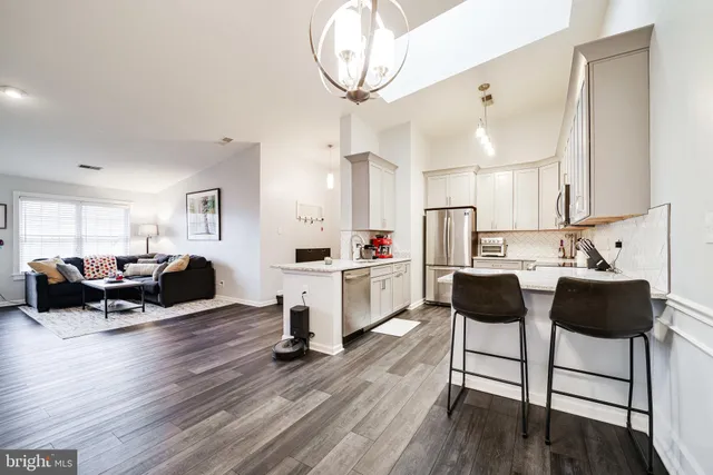 a living room with kitchen island furniture and a wooden floor