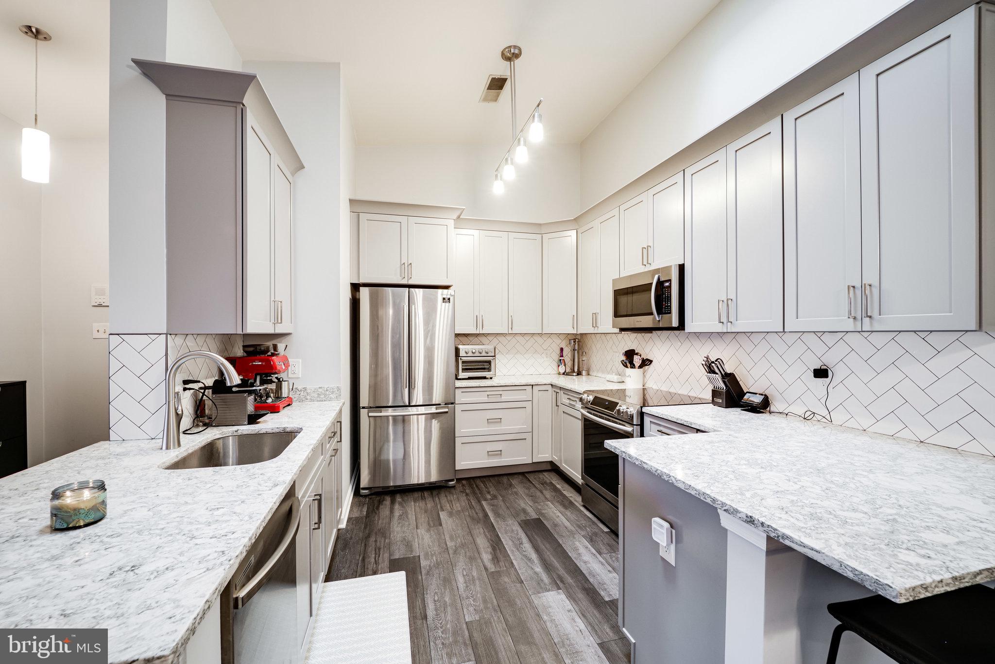7510 Ashby Lane, Unit J Alexandria, VA 22315 - Photo 15 of 53 a kitchen with a sink stove top oven and refrigerator