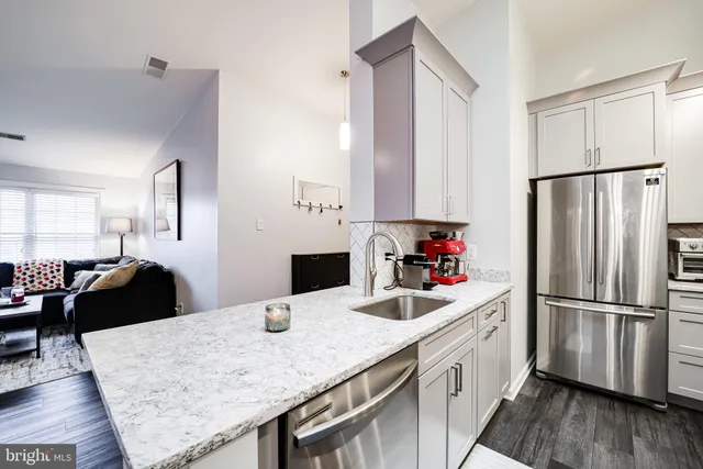 a kitchen with a sink stove and refrigerator
