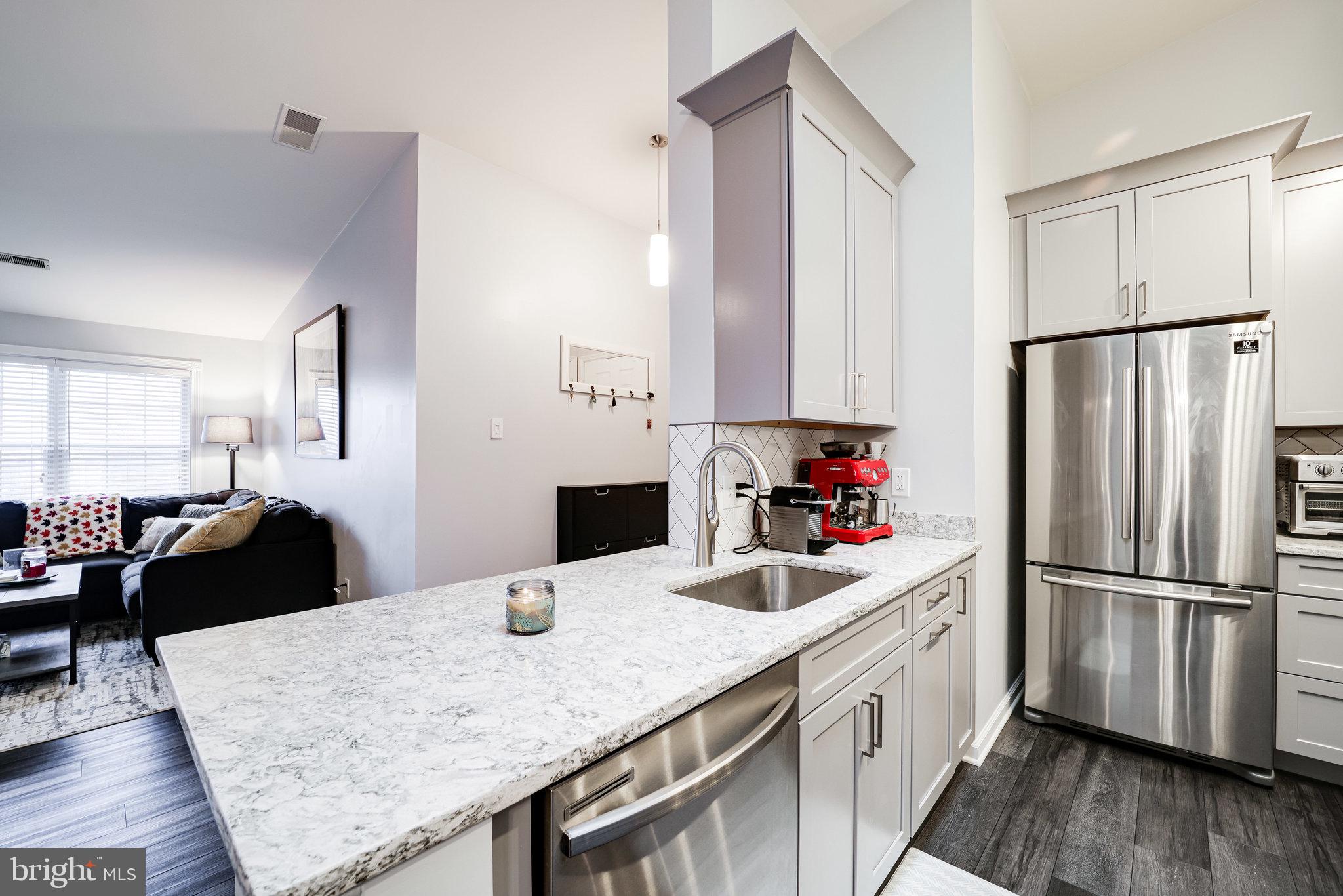 7510 Ashby Lane, Unit J Alexandria, VA 22315 - Photo 16 of 53 a kitchen with stainless steel appliances granite countertop a refrigerator and a sink