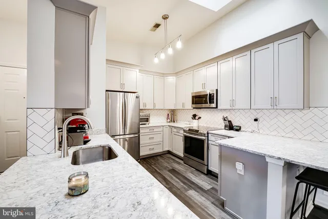 a kitchen with a sink a stove and cabinets