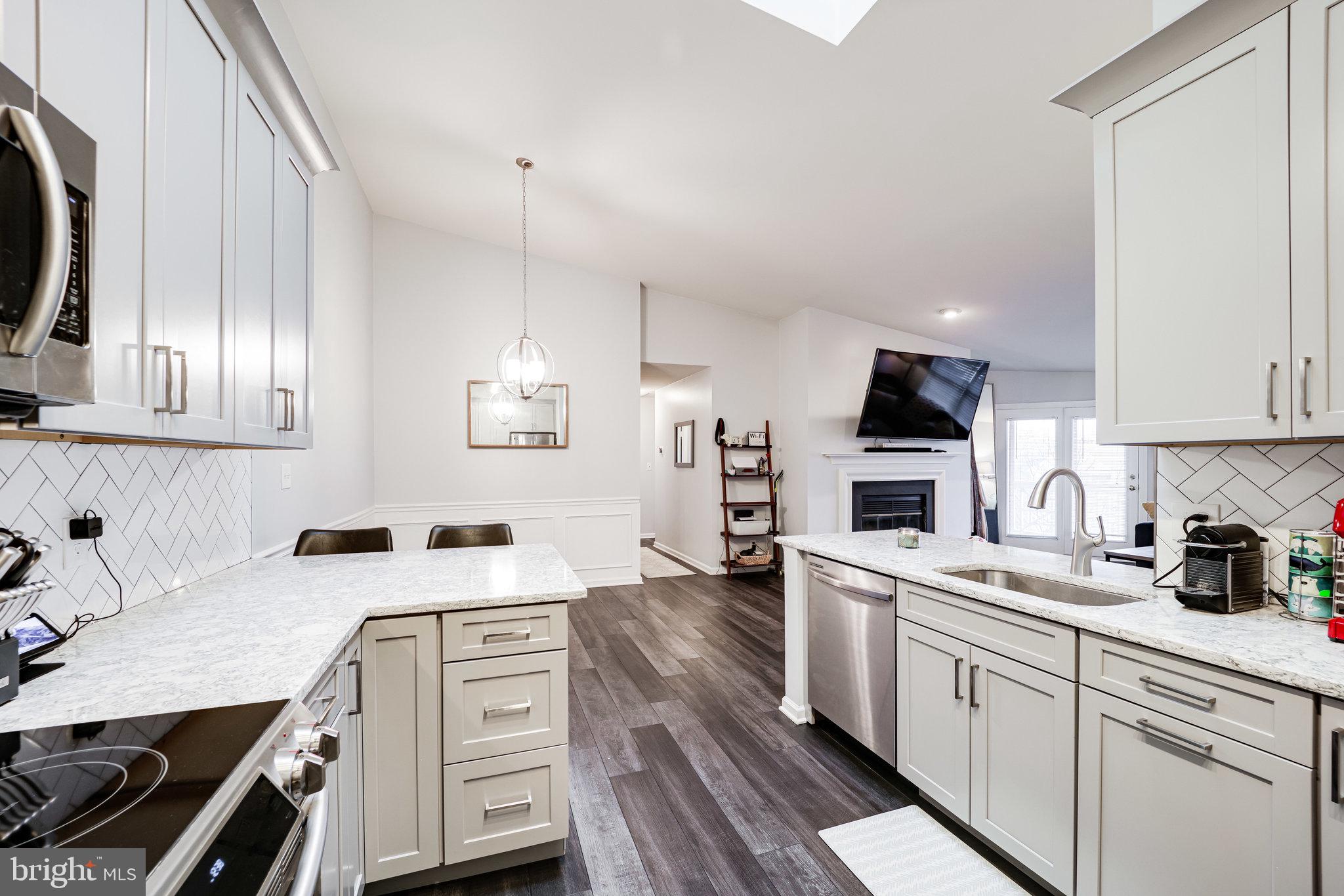 7510 Ashby Lane, Unit J Alexandria, VA 22315 - Photo 18 of 53 a kitchen with a sink a stove and cabinets