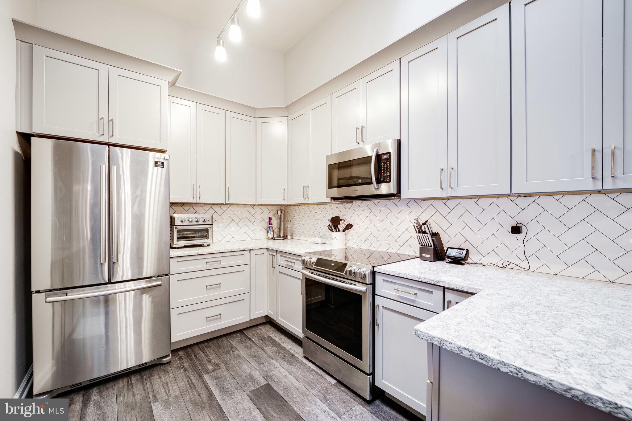 7510 Ashby Lane, Unit J Alexandria, VA 22315 - Photo 2 of 53 a kitchen with a sink appliances and cabinets