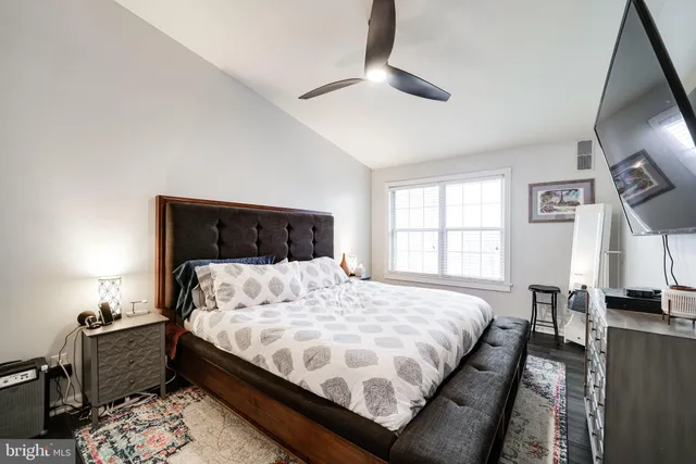 a bedroom with bed tv and window