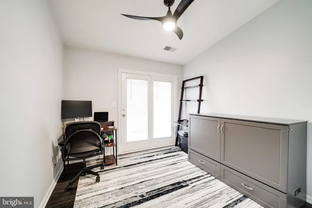 a view of a room with wooden floor and cabinet